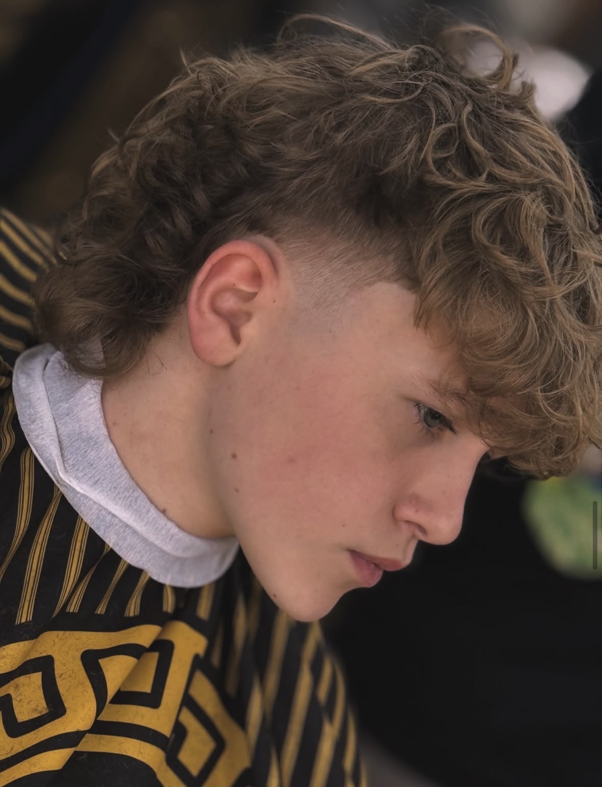 Curly textured mullet with a skin fade